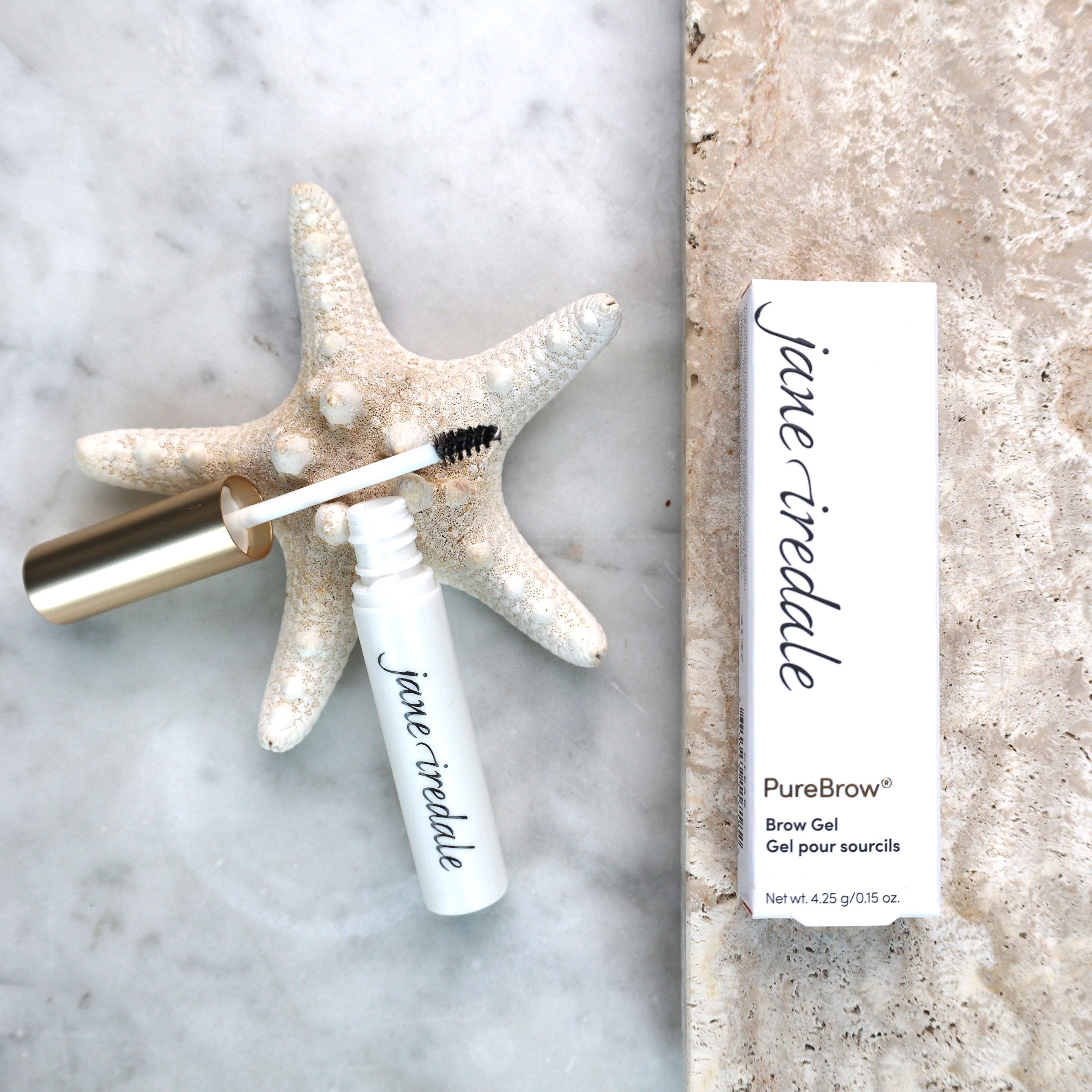 Jane Iredale Purebrow Gel klar bryngelé og emballage på marmor med søstjerne